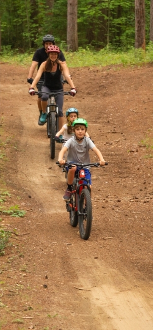 Children biking on dirt road