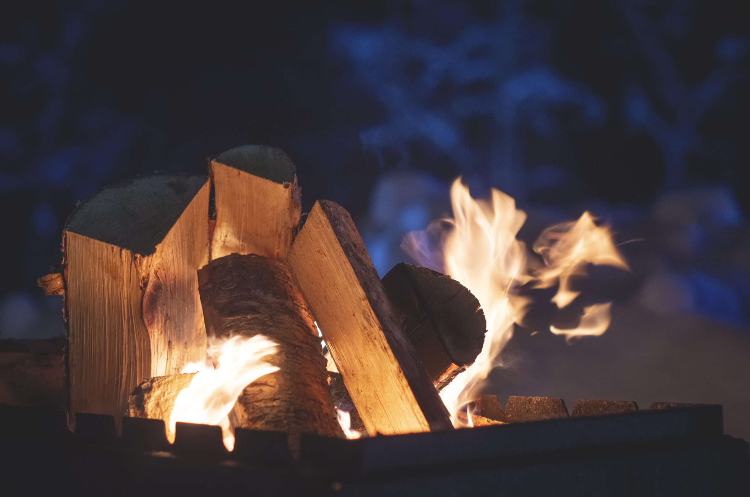 Photograph of a camp fire, close up of the wood and flames